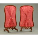 A pair of Victorian mahogany fire screens, of shaped outline,