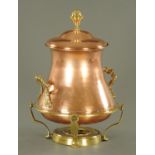 A large brass and copper lidded urn. Height 51 cm.