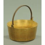 A large 19th century brass preserve pan, with loop handle. Diameter 37 cm.
