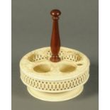 An English creamware cruet stand, moulded and pierced circular form, with replacement wooden handle.