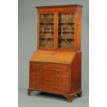 A mahogany bureau bookcase, 19th century, with astragal glazed doors enclosing adjustable shelves,