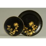 Two Japanese lacquered plaques. Diameters 47 cm and 30 cm.
