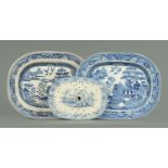 Two large willow pattern blue and white transfer printed ashettes, together with a draining dish.