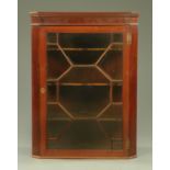 A George III mahogany glazed corner cupboard,