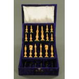 An Indian carved boxwood and ebony chess set, late 20th century, in plush lined fitted box.