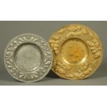 Two pressed metal plaques. Largest diameter 41 cm.