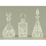 Three cut glass decanters, each with stopper. Tallest 30 cm.