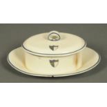 A Wedgwood creamware butter dish and cover, decorated with an armorial shield. Length 22 cm.