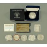 Silver coins comprising an American one ounce fine silver dollar,