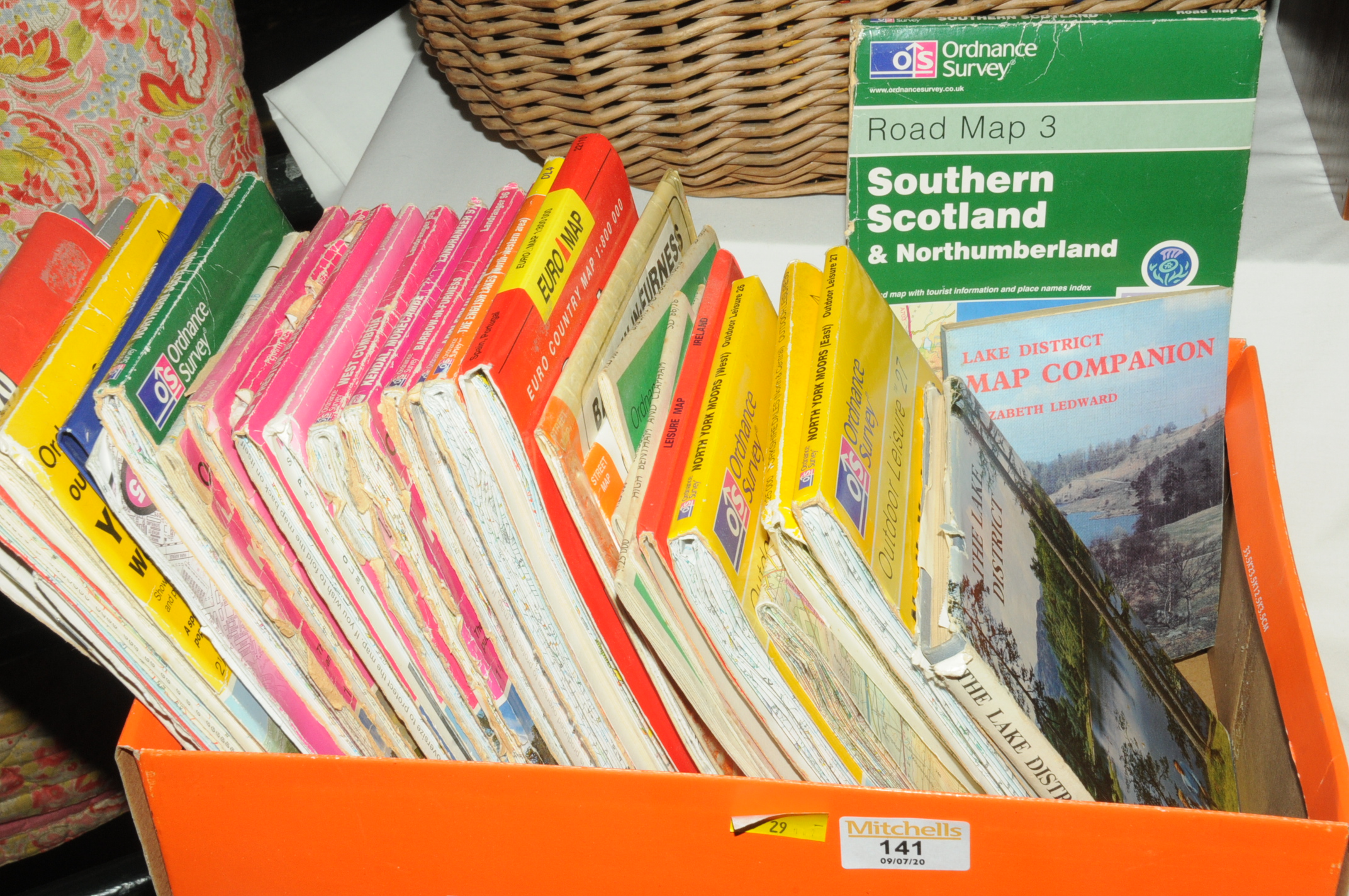 Box of ordnance survey maps and Lake District books