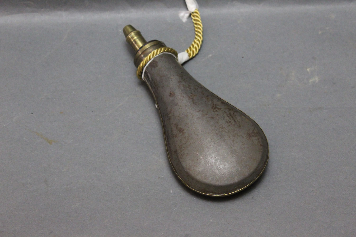 W Sykes brass and tin powder flask, with standing brass seam. Length 20 cm.