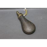 W Sykes brass and tin powder flask, with standing brass seam. Length 20 cm.