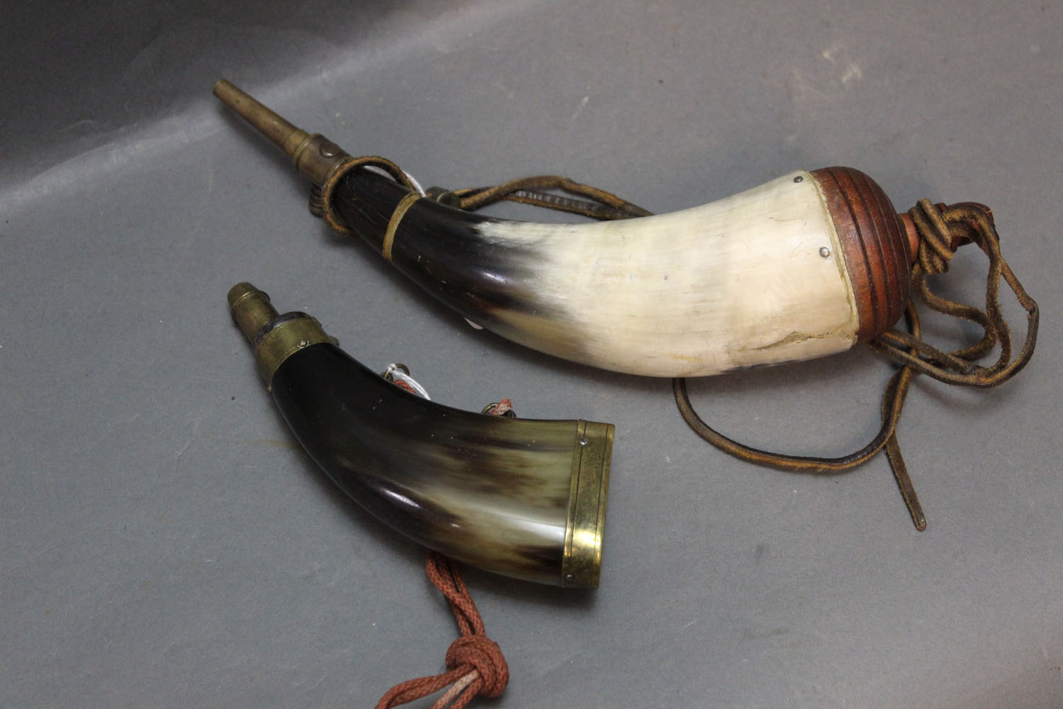 Two reproduction cow horn flasks.