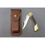 Puma Duke folding knife model 210 905 with 3 1/4" blade and antler scale handle, with sheath.
