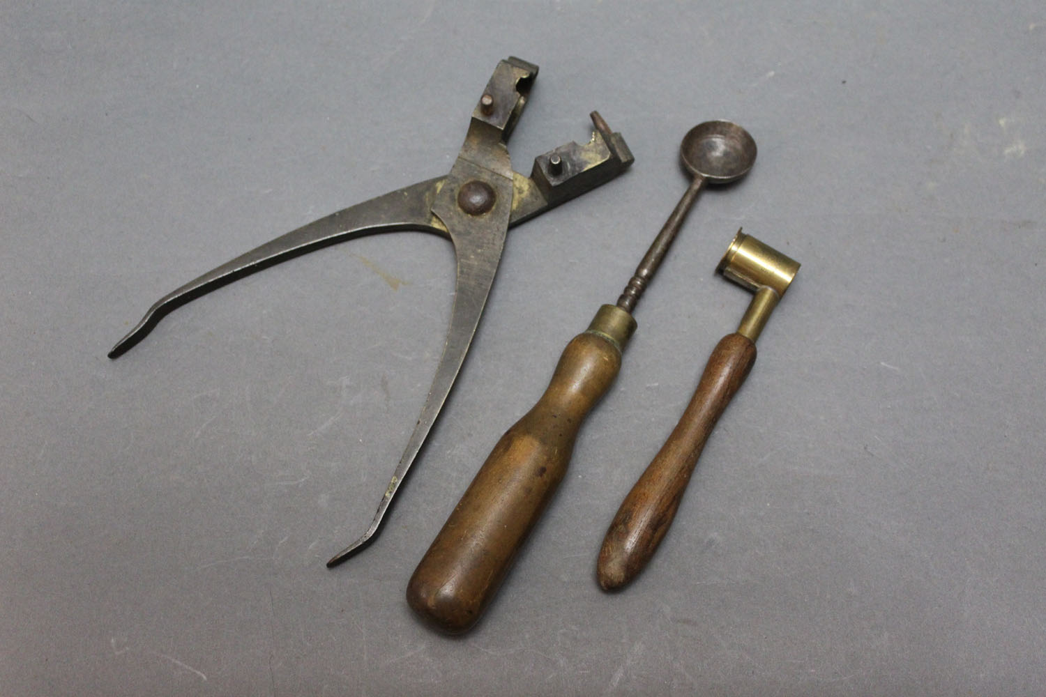 Large brass musket ball mould, powder measure and lead pourer.