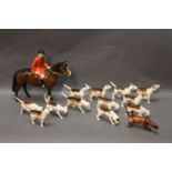 Beswick, huntsman mounted on brown horse and 7 first Version foxhounds, 5 Second Version and a fox.