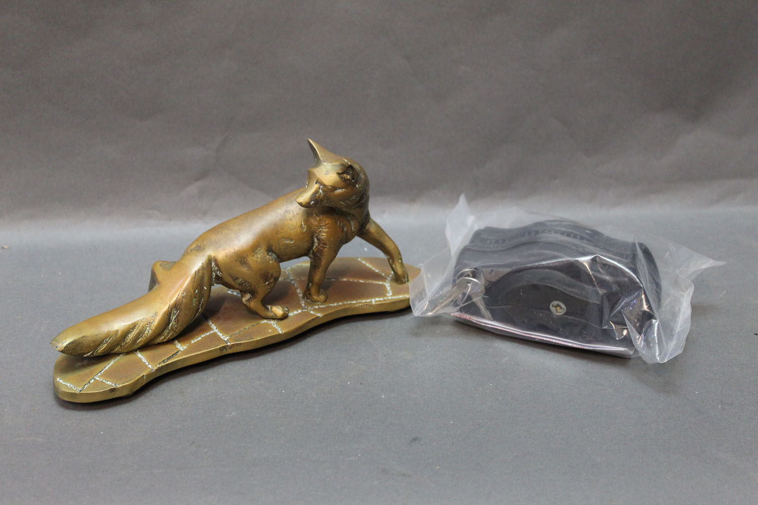 Regal gun locking device, unused, and a brass fox, length 24 cm.