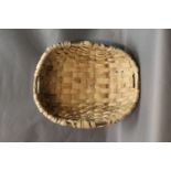 In the manner of Owen Jones, an oak swill basket, made from coppiced oak and a hazel rim.
