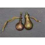 Brass and copper pistol flask, 11 cm, and a copper and brass flask decorated with ducks.