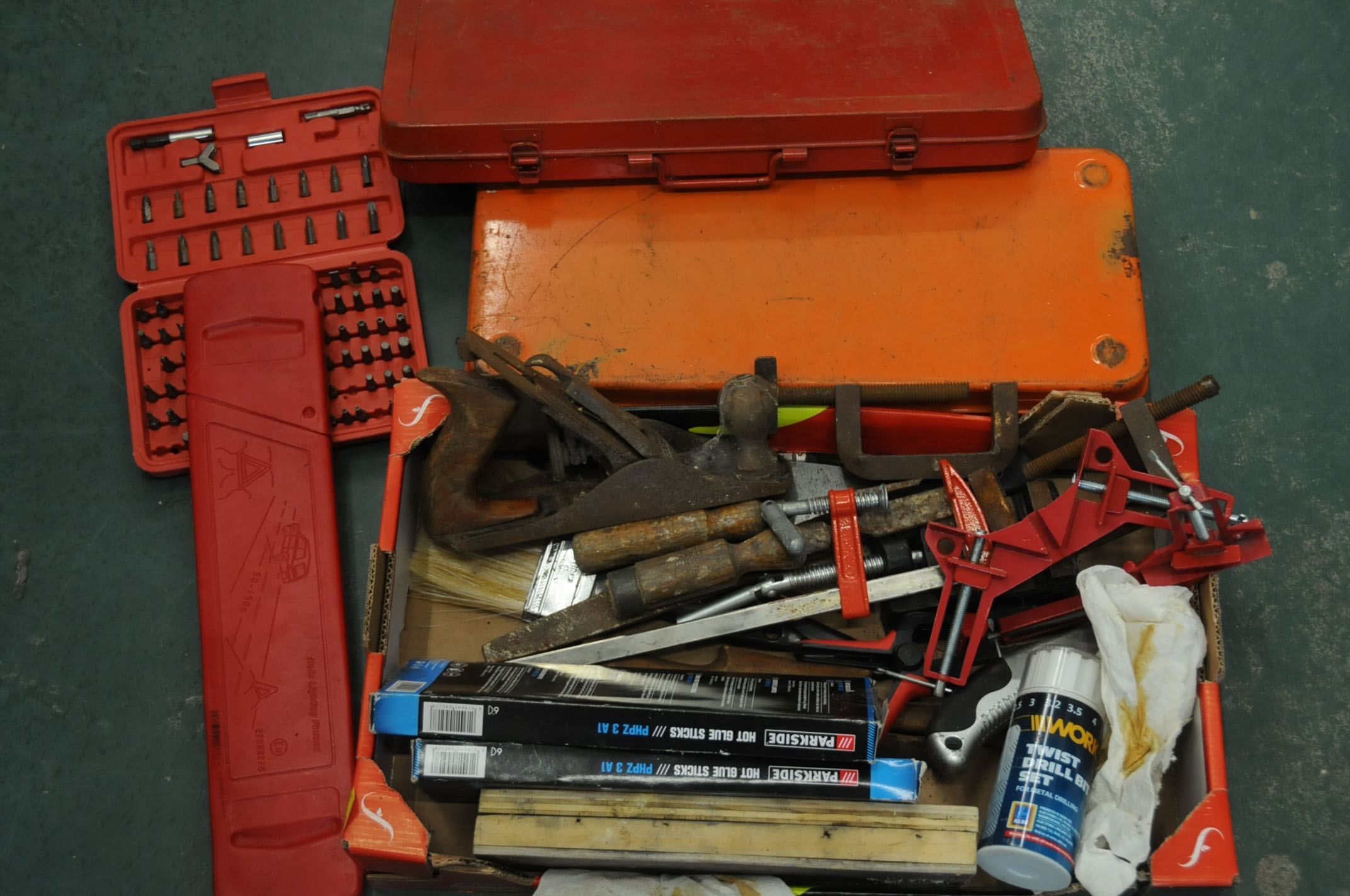 Box of toolboxes, sharpening stone, hot glue sticks, clamps, etc.