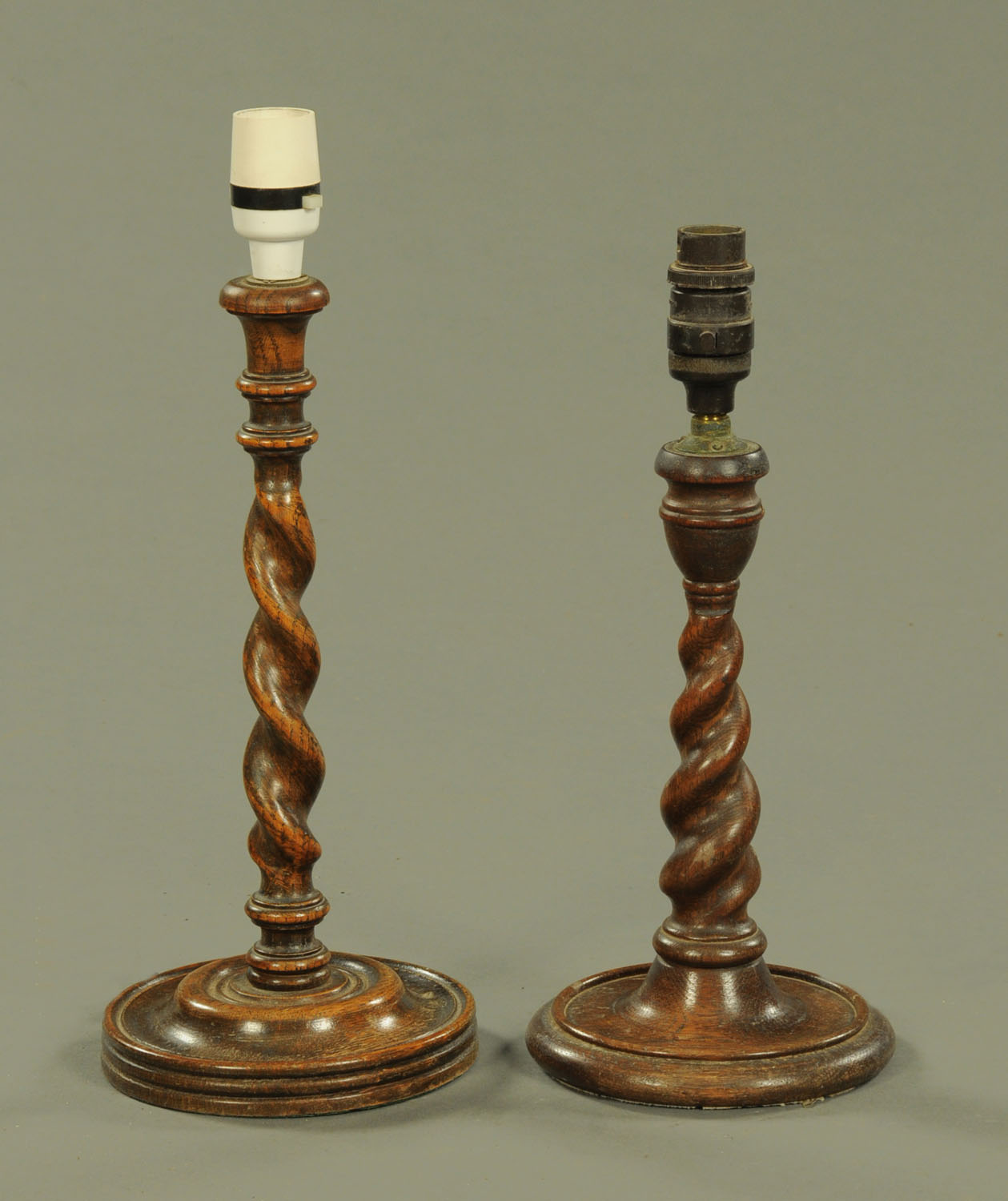 Two oak twist column candlesticks, converted to electricity. Height excluding light fitting 33 cm.