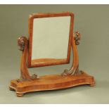 A large Victorian mahogany toilet mirror, with serpentine front and raised on short bun feet.
