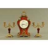 A faux tortoiseshell and brass mounted clock garniture, bearing plaque dated 1917,