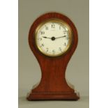 An Edwardian inlaid mahogany balloon shaped mantle clock, with single train French movement.