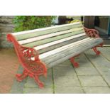 A large Victorian Falkirk garden bench, with three cast iron supports and slatted seat.