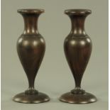 A pair of turned hardwood Treen vases, of inverted baluster form on circular foot. Height 21.5 cm.