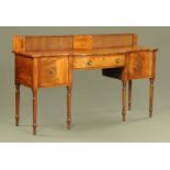 A Regency mahogany sideboard, with stage back and bowfront and raised on turned tapered legs.