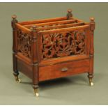 A Victorian rosewood Canterbury, three divisions, with fretwork sides and single drawer,