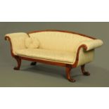 A Regency mahogany framed settee, upholstered in foliate patterned material,