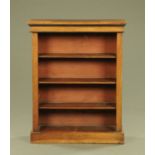 An Edwardian mahogany veneered open bookcase, raised on a plinth base.