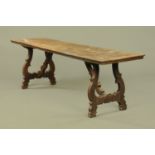 An 18th century Spanish walnut refectory table, with scrolling end supports.