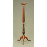 A 19th century mahogany torchere, with circular top,