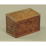 A carved walnut slope front stationery casket. Width 24 cm.