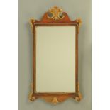 A George II style walnut framed mirror, with gilt Prince of Wales plume. Height 80 cm, width 43 cm.