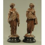 A pair of Continental spelter figures, each raised on a wooden plinth. Height 50 cm.
