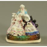 A 19th century Continental porcelain family group inkwell, the top lifting to reveal inkwells,