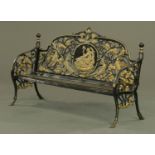 A Victorian style cast iron garden bench, with pierced cast back and slatted seat.