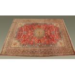 A Persian wool fringed carpet, principal colours red, blue, green and beige.