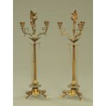 A pair of 19th century bronze three branch candelabra, with tapered columns,