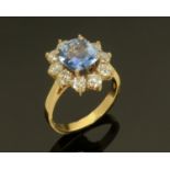 An 18 ct Ceylon sapphire and diamond cluster ring, yellow gold, sapphire +/- 0.