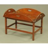 A mahogany butlers tray coffee table, raised on a stand, detachable.