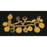 A heavy 9 ct gold charm bracelet, manufactured from an Albert chain and complete with 1787 guinea,
