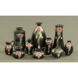 Ten pieces of Shelley Carnation ware, with black ground. Tallest 24 cm.