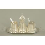 An Eastern silver coloured metal condiment set on tray, decorated with palm trees, camel,