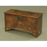 An antique oak six plank coffer, with carved frieze and original lockplate. Width 78 cm.