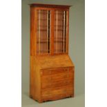 A mahogany bureau bookcase, with moulded cornice above a pair of glazed doors with wooden astragals,